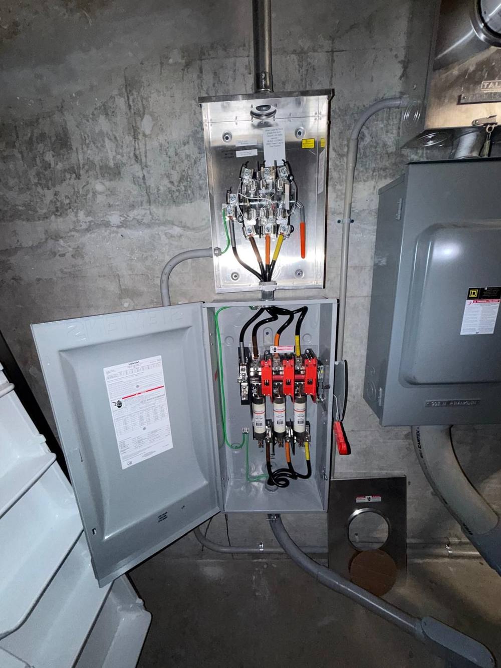 Meter can and fused disconnect on bare concrete wall