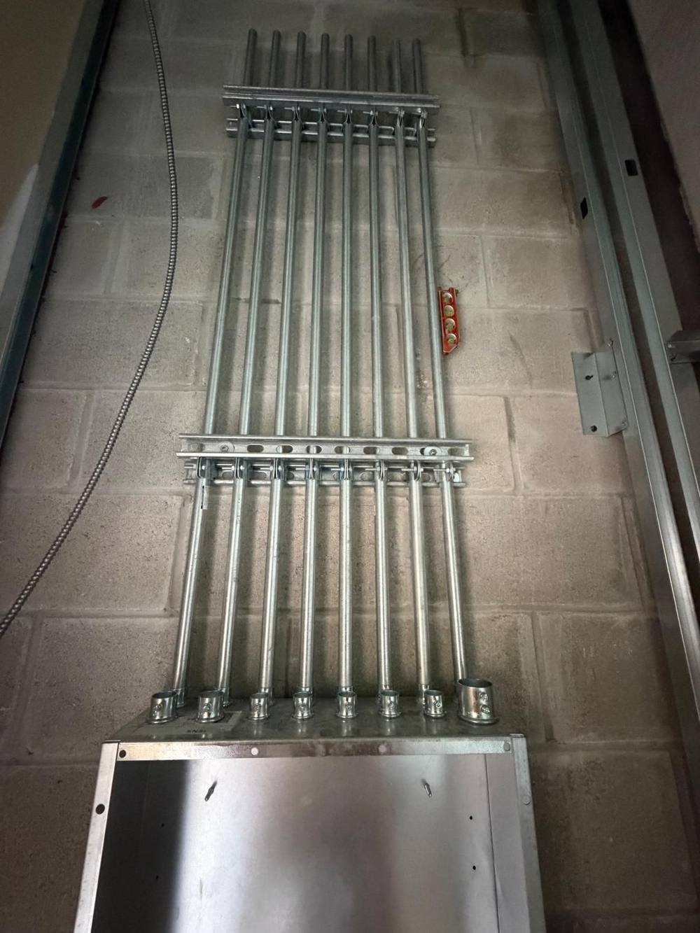 Rigid conduit stub-ups roughed in before panel installation