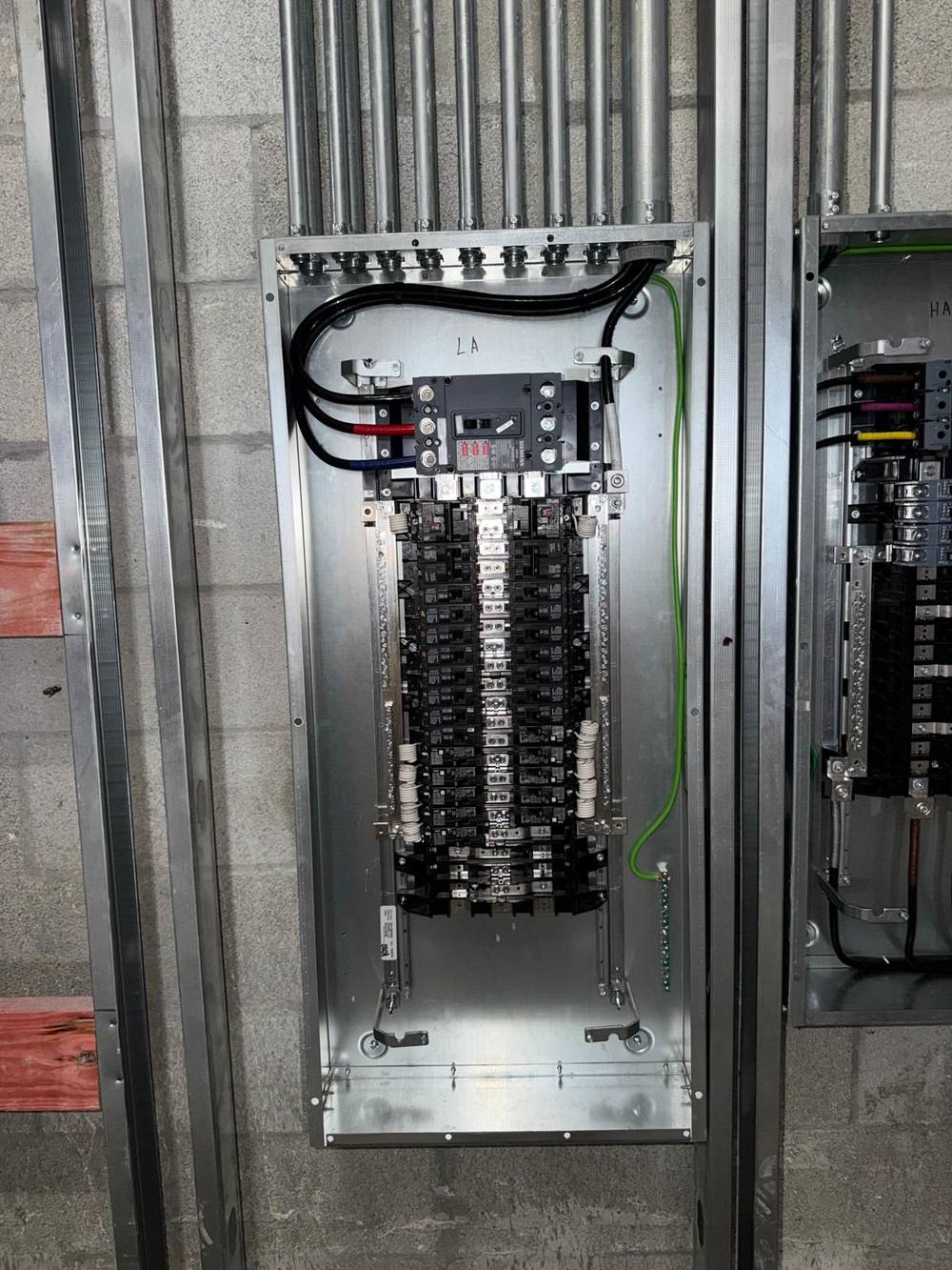 Panelboard LA with breakers, main breaker, and grounding conductor